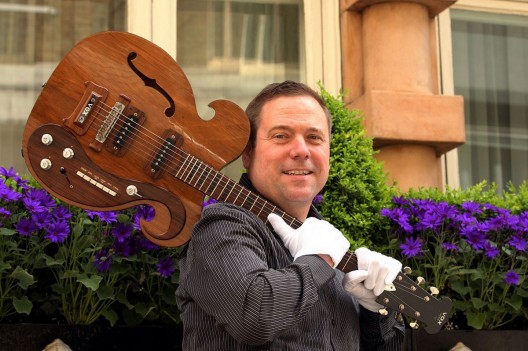 Darren Julien, president of Julien's Auctions, with the VOX guitar